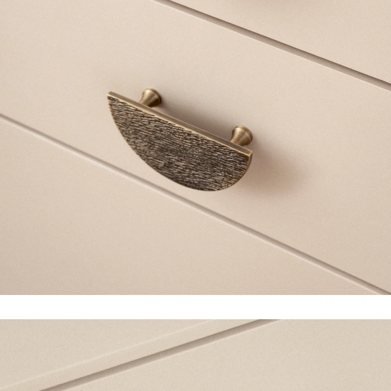 half circle cabinet handle installed on wooden drawer