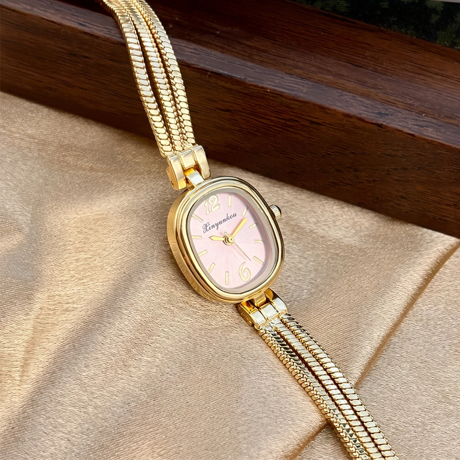 Elegant Gold Ladies' Watch with Oval Bead Face and Fringe Tassel Band