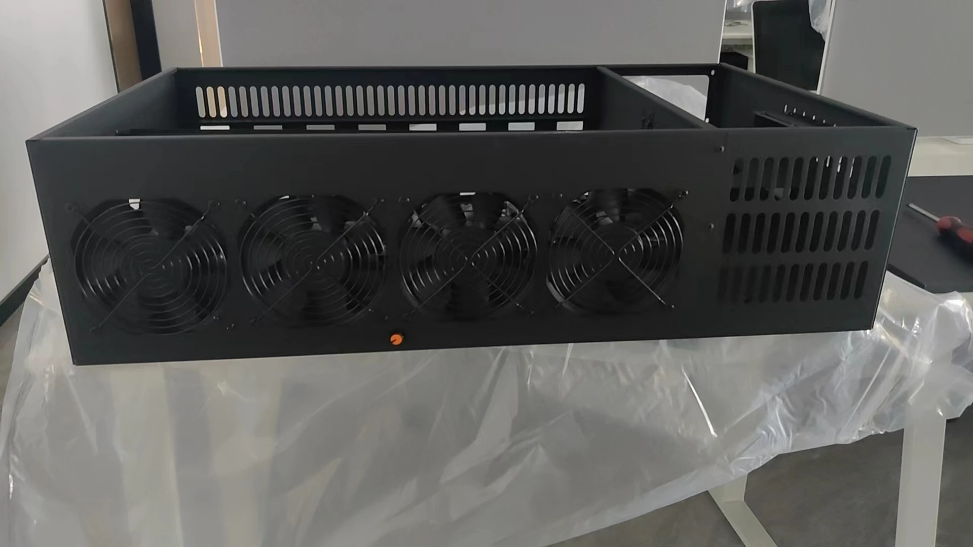 A set of eight PCI card slots in a miner's chassis. The mainboard model is ETH B85 V2.11. There is one fan on the mainboard