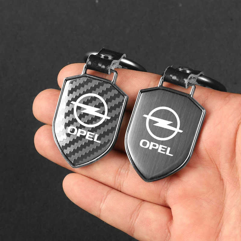 

New carbon fiber gloss black Shield Car KeyChain Fashion Business Gift For Opel Astra corsa insignia Mokka Vectra Vivaro Antara