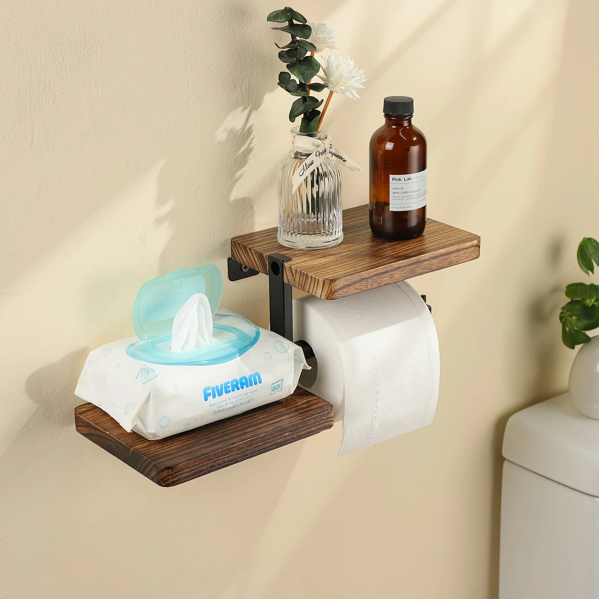 Wooden bathroom shelf holder in use with candle and small plant on shelf