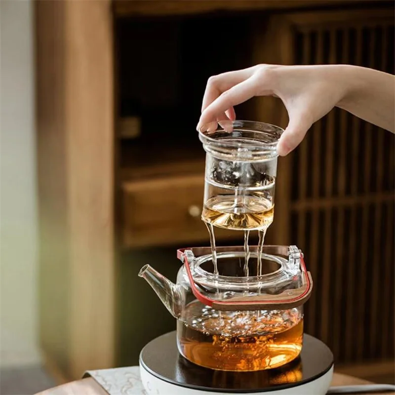 https://ae01.alicdn.com/kf/S6dba2e1cf9ec47e98e99ad5e49f849dd4/1000ml-Magnetic-Suction-Wooden-Handle-Beam-Glass-Teapot-With-Tea-Strainer-Steaming-and-Boiling-Flower-Tea.jpg