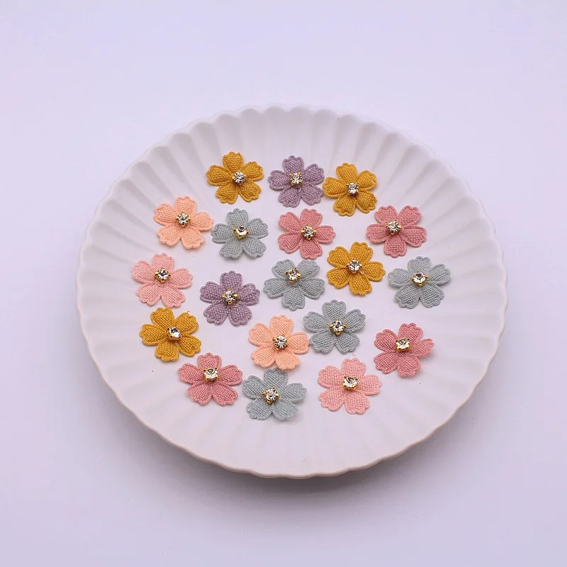 A set of 20 small fabric flower patches, perfect for use in projects, hair accessories, headbands, bows, and hat dec