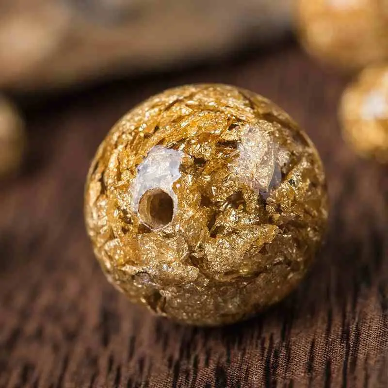 

Gold leaf beads scattered