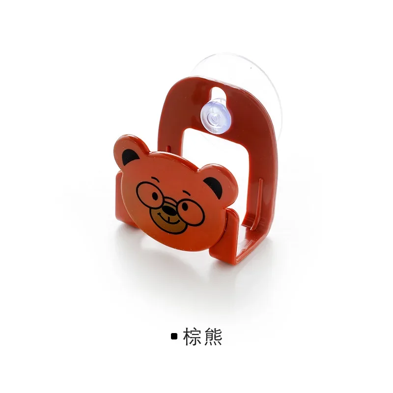 Cartoon-themed kitchen organizer rack holding sponge and rag, mounted near sink with colorful kitchen accessories brown