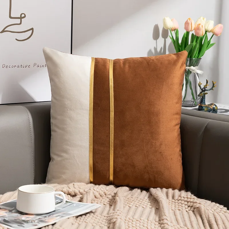 Brown and white velvet pillow cover with decorative gold-tone stripes