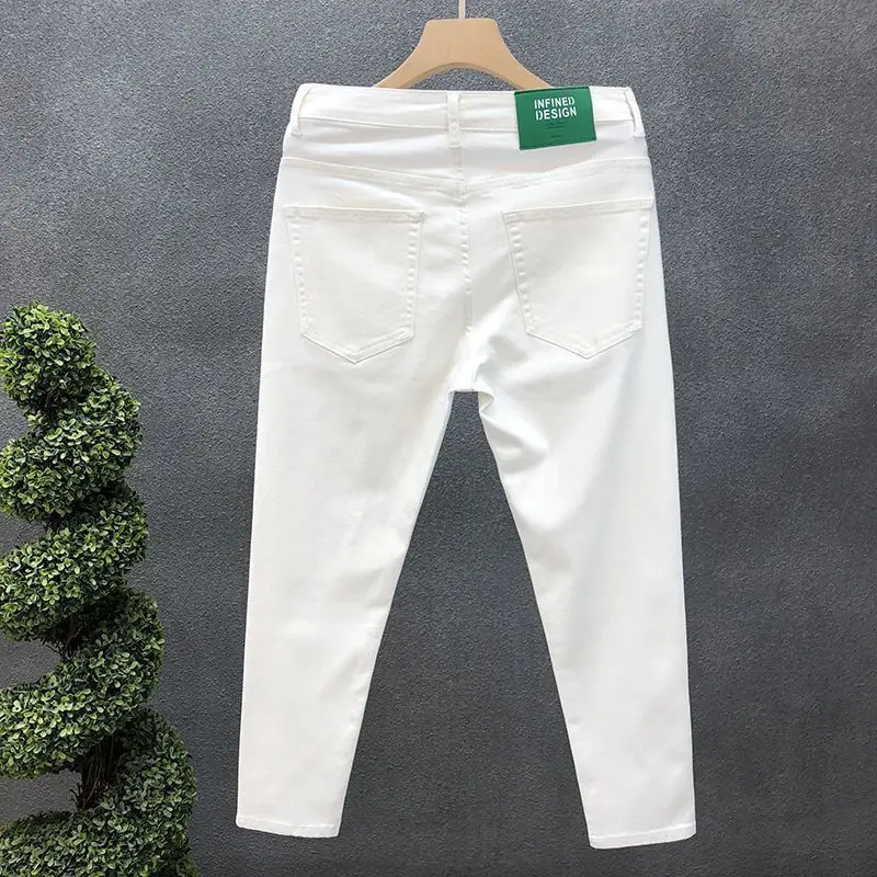 Modny luksusowy projektant męski biały czarne dżinsy Slim Fit koreański styl Stretch spodnie dżinsowe na lato obcisłe dżinsy rurki męski