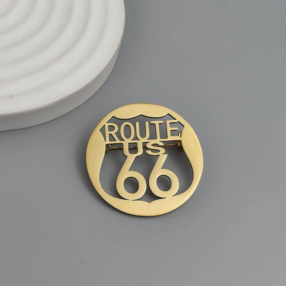 Route 66 hollow-cut stainless steel lapel pin in Gold finish, worn on jacket lapel