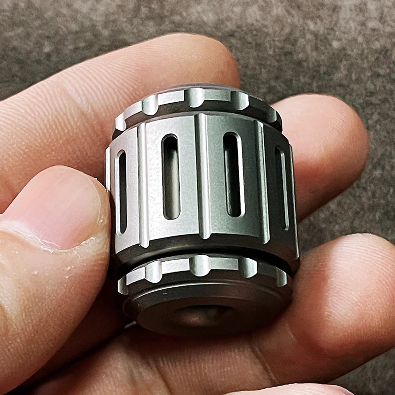 Gyro pendant placed beside everyday carry items