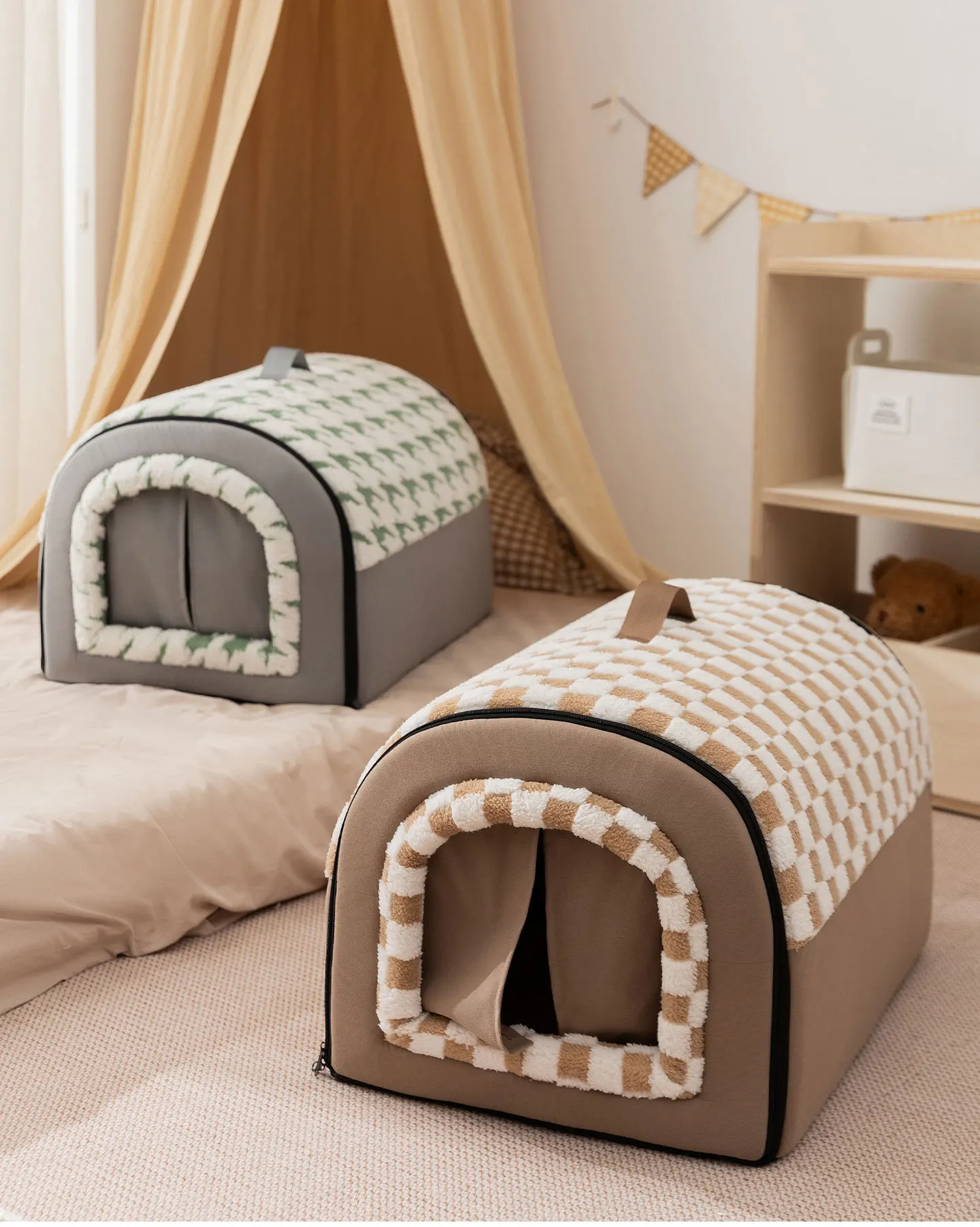 Two curved cat house beds, one in green houndstooth and one in brown checkerboard, styled in a cozy, minimalist room with soft lighting and a decorative tent in the background.