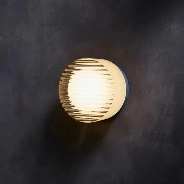 Close up of circular glass stone wall lamp