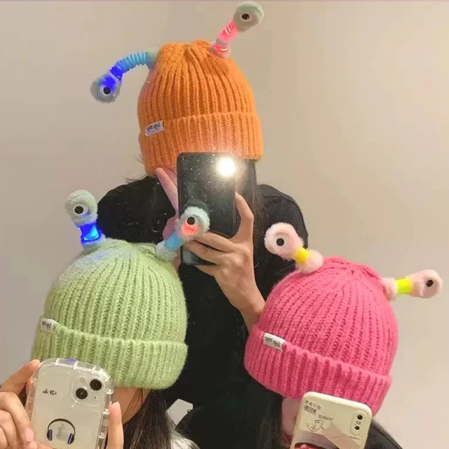 Stay warm and stylish with the Autumn and Winter New Funny Cartoon Glowing Little Monster Bucket Knitted Hats.