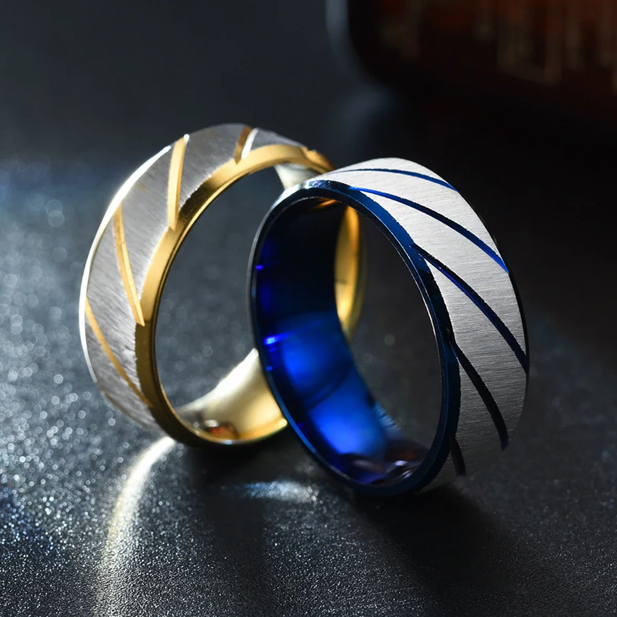 Stainless steel wave pattern couple rings showing irregular modern design.