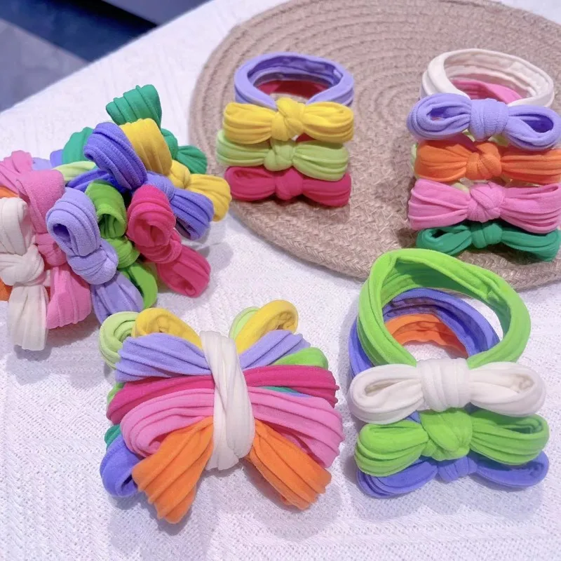 alt="Velvet Hair Ties, a pack of 10 Pastel Bow Scrunchies.