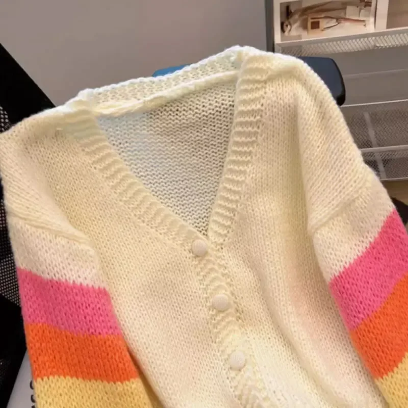 Women's vibrant rainbow striped knitted cardigan sweater.