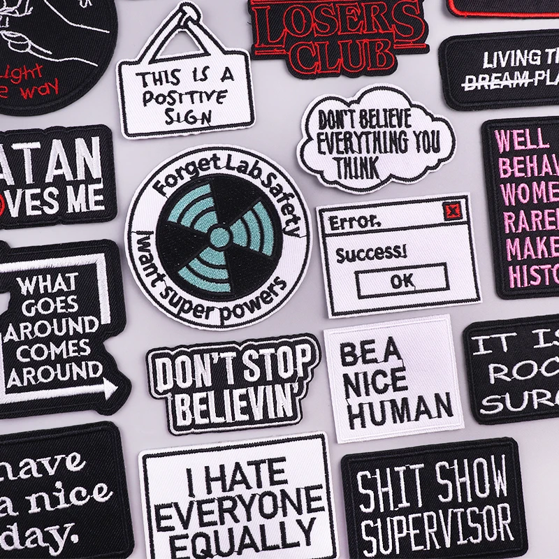 Funny slogan iron-on embroidered patches with quotes like “Don’t Stop Believin,” “Forget Lab Safety,” and “I Hate Everyone Equally”