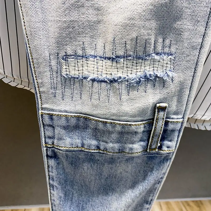 Autumn style high street color contrast patchwork ripped jeans men's trendy beggar slim fit small foot long pants Korean version