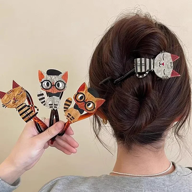 A woman with a hair twist wears three colorful KittyNook Cat Co. Acrylic Cat Hairpins—fun cat lover accessories.