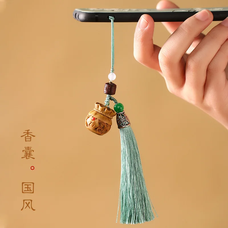 

Green sandalwood hollow blessing bag sachet keychain Chinese style retro incense pill aromatherapy mobile phone pendant can open