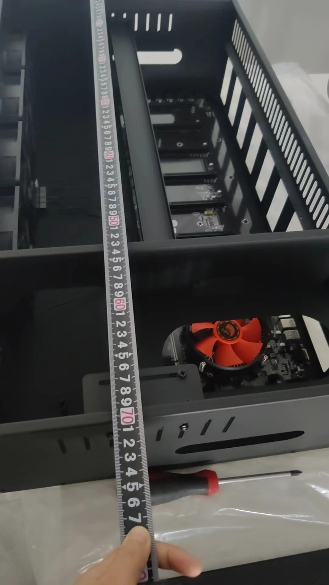 A set of eight PCI card slots in a miner's chassis. The mainboard model is ETH B85 V2.11. There is one fan on the mainboard