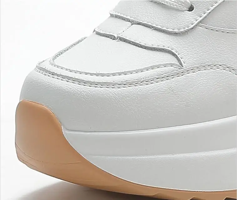 Close-up of the toe box highlighting stitching and caramel-colored rubber bumper.
