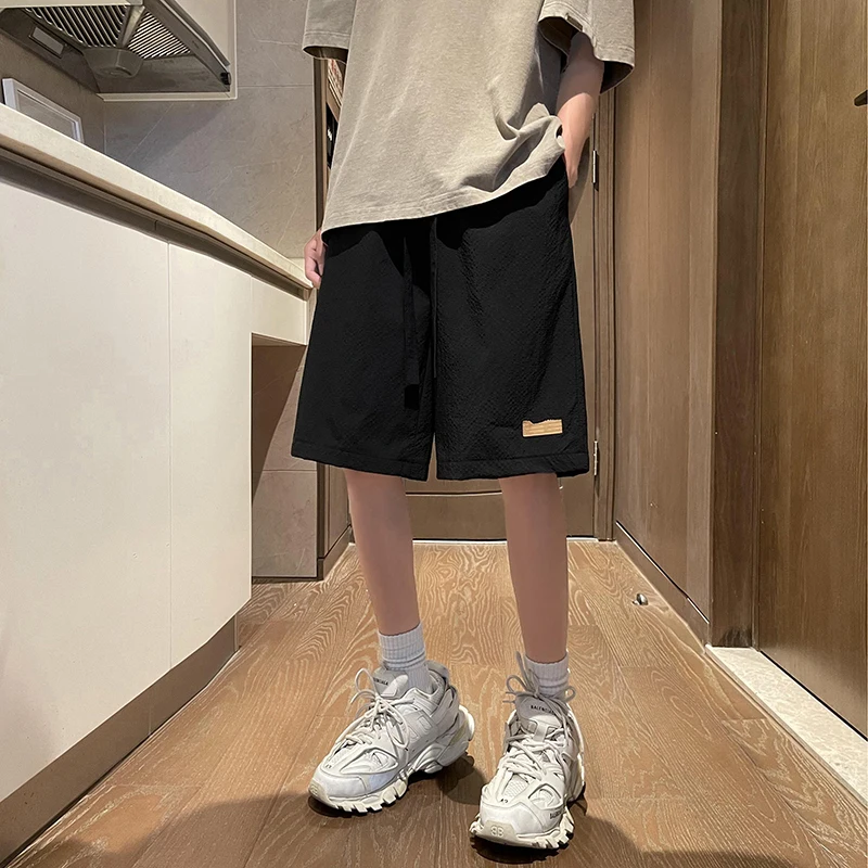 Fashion Solid Color Spliced Pockets Casual Shorts Men's Clothing 2024 Summer New Loose Elastic Lace Up High Waist Knee Shorts