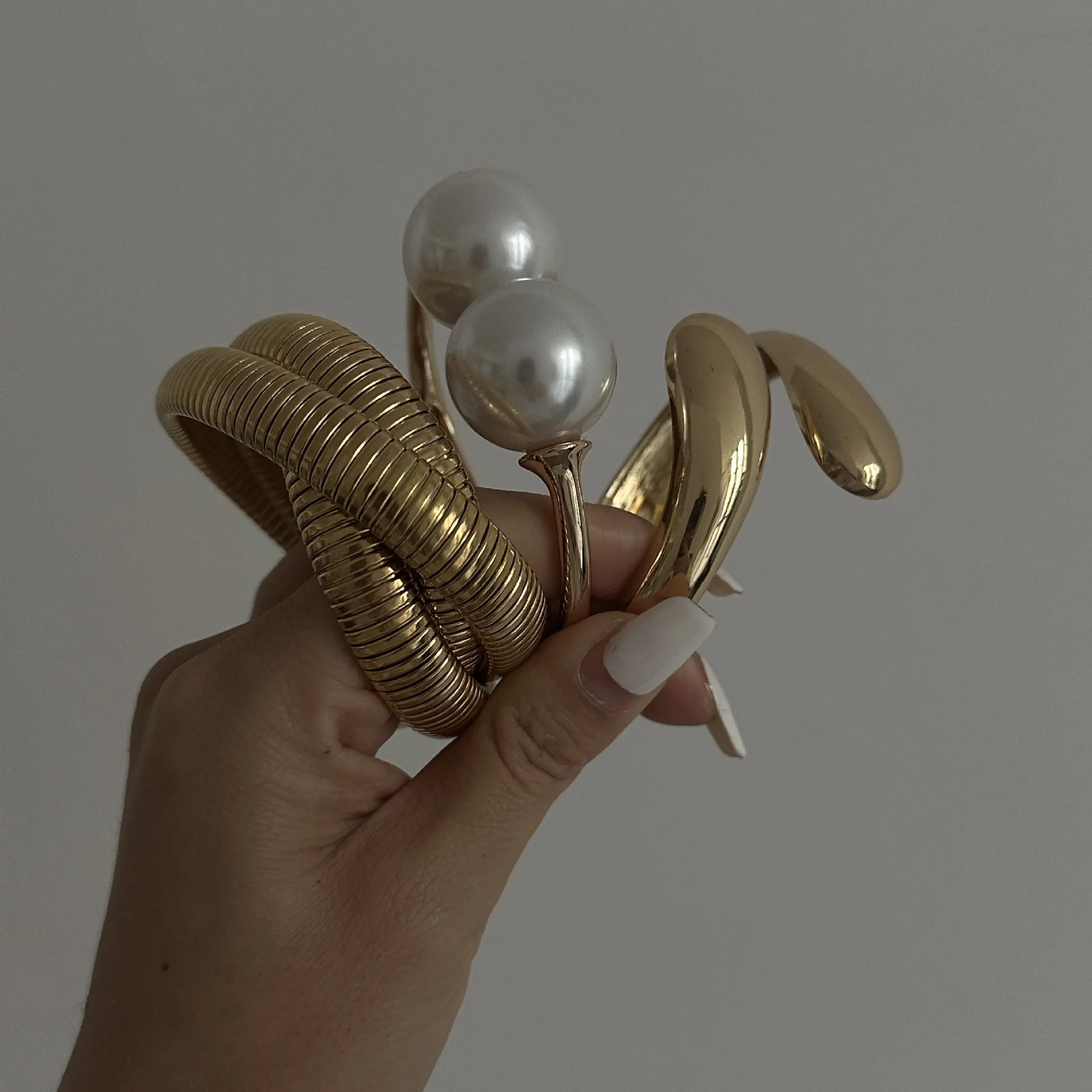 Gold-tone cuff bracelet with pearl ends for women – wide statement bangle with modern fashion appeal.