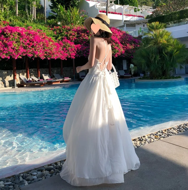 

2023 Elegant Summer Seaside Holiday Beach Skirt White Minority Suspenders Leaky Back Dress Women Summer Seaside Holiday Ins