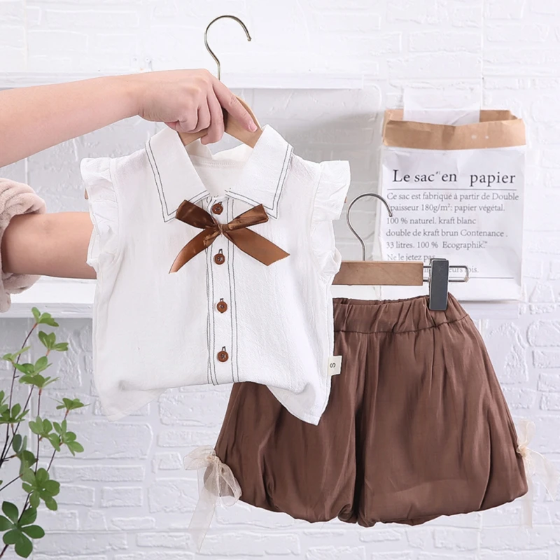 Adorable toddler girl 2-piece outfit featuring a bow top with flying sleeves and matching shorts, perfect for girls aged 0-4 years.