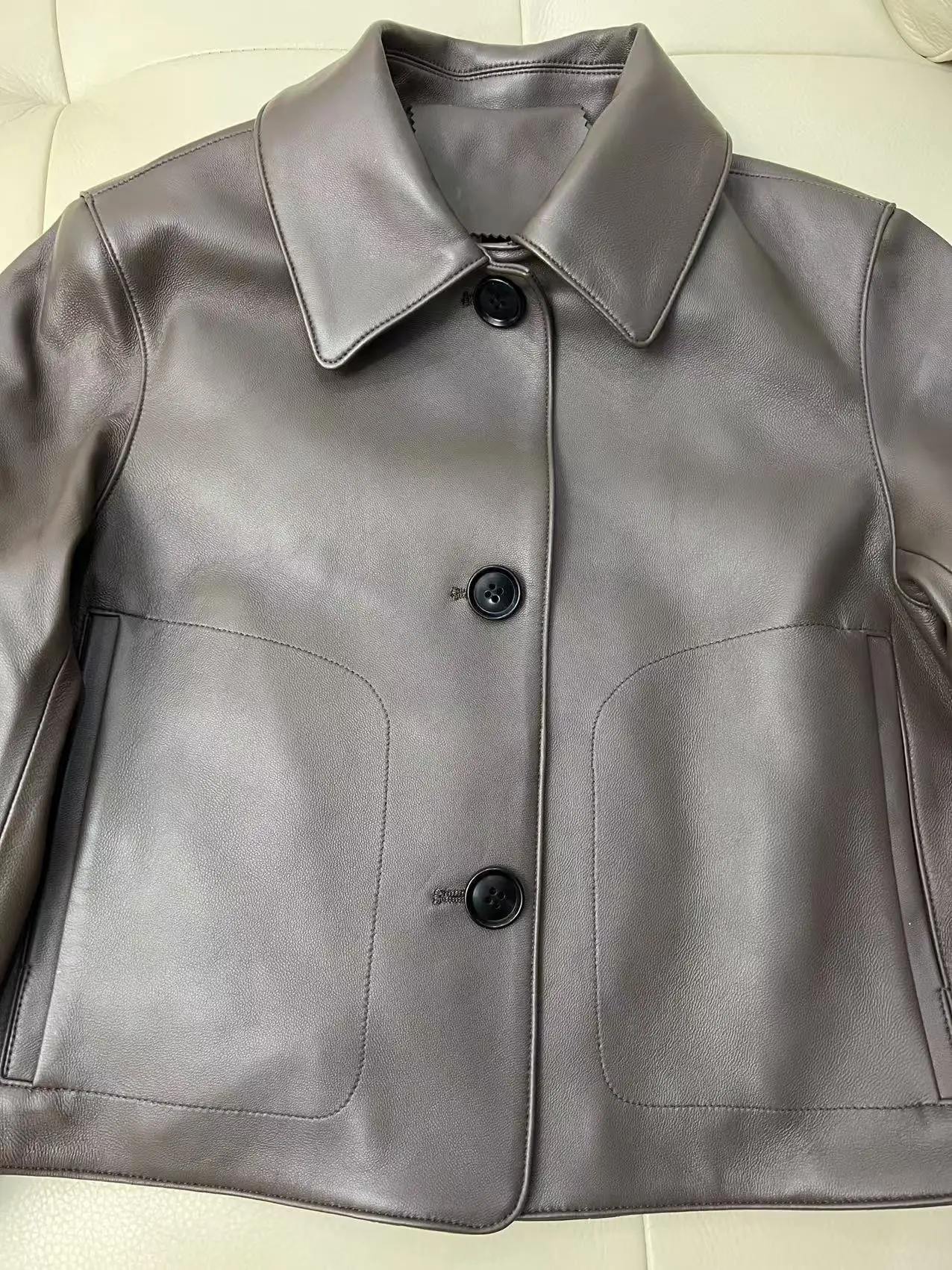 Model wearing light caramel jacket