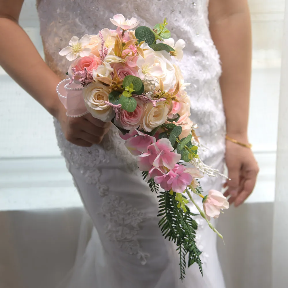 Water droplets from waterfall, bride and bridesmaid holding flowers, wedding gift