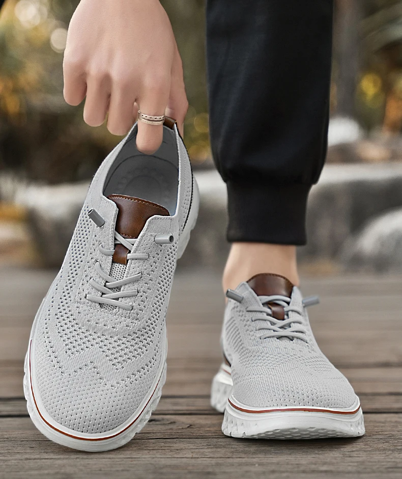 Pair of brown mesh sneakers with soft soles placed on a concrete surface, highlighting breathable texture and sporty silhouette