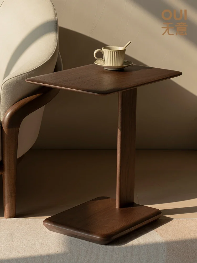 

A few black walnut small coffee tables near the solid wood sofa are luxurious, and a few movable multifunctional side tables in