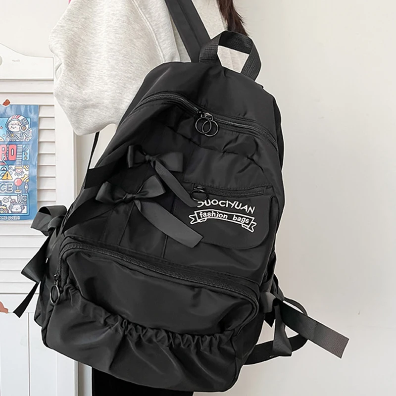Stylish kawaii backpack with bowknot detail, designed for women and girls, featuring soft pastel tones and spacious compartments for school essentials. black 2