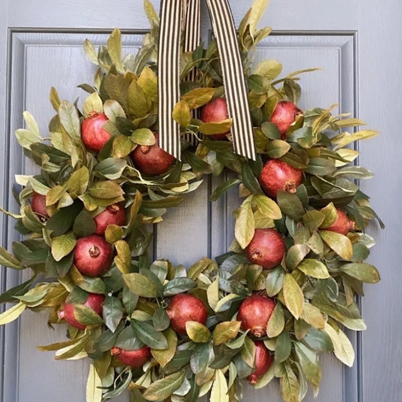 

Simulated Pomegranate Fruit Wreath Green Plant Autumn Colored Harvest Decorations Hanging In Front Of The Door