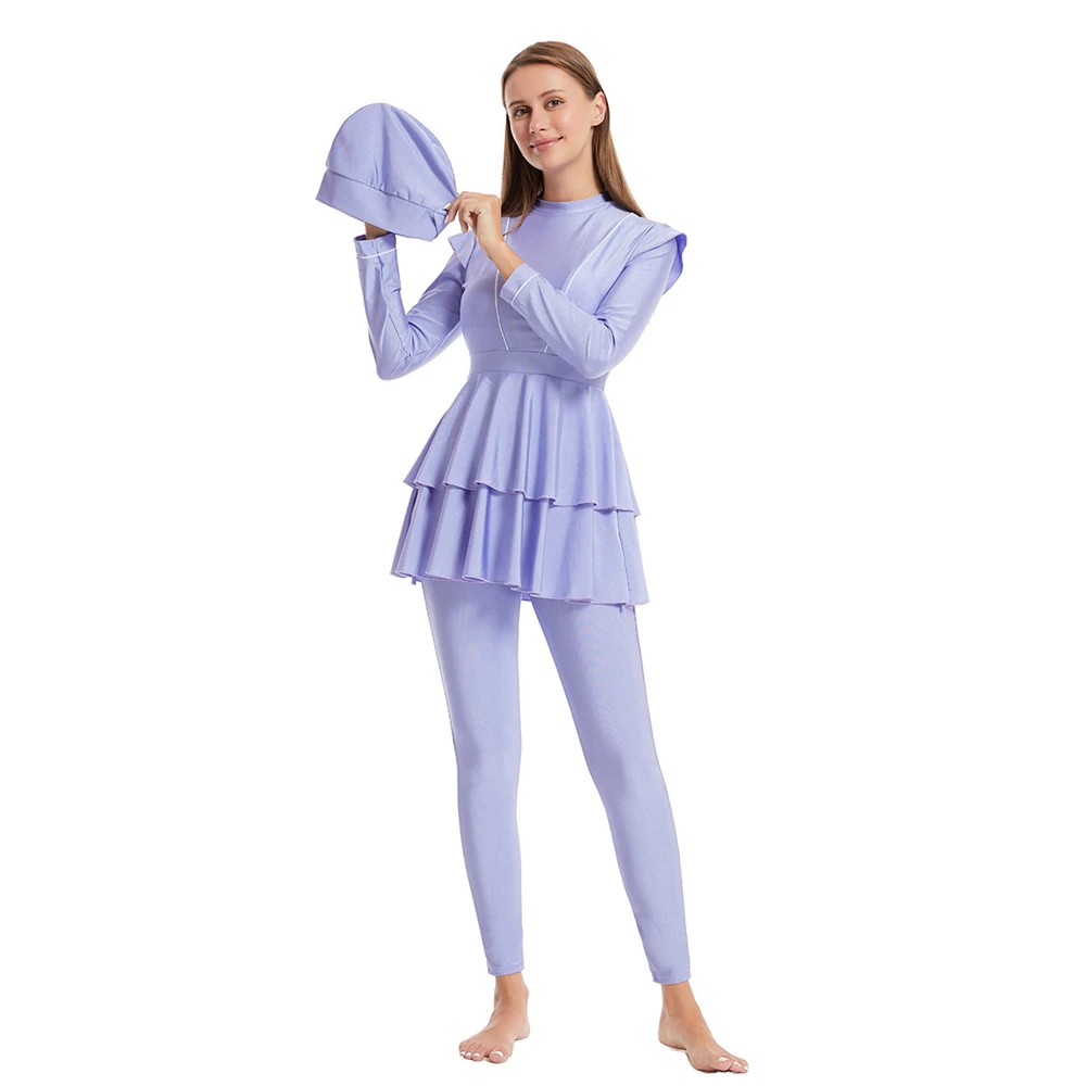 Product display of modest burkini set with V-neck top and mini ruffle skirt in purple blue