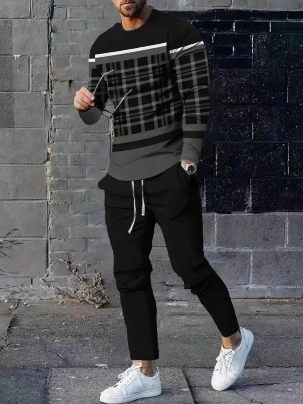 Man wearing striped patchwork long sleeve top and pants set in a sunny outdoor setting black