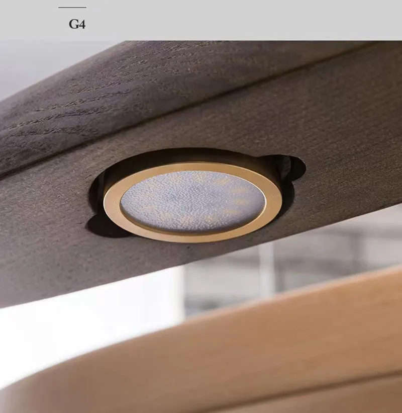 Close-up of a Spiral Wood Pendant Light featuring a round gold-trimmed fixture installed in wood, perfectly complementing an organic modern lighting aesthetic.