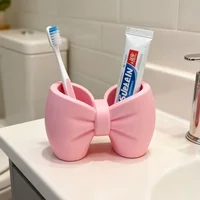 A desktop decoration item, shaped like a macaron-colored bow, can be used as a pen holder. 3