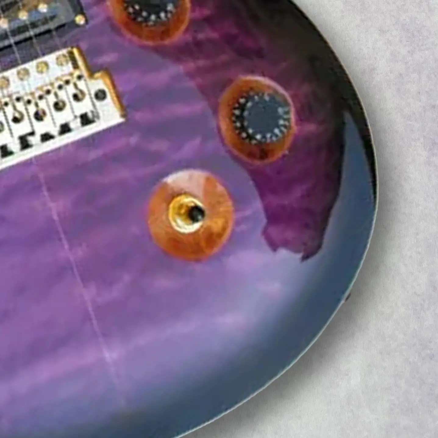 

Custom Electric Guitar with Flame Maple Top, Purple & Black Body, Tremolo Bridge, Gold Hardware，6 Strings