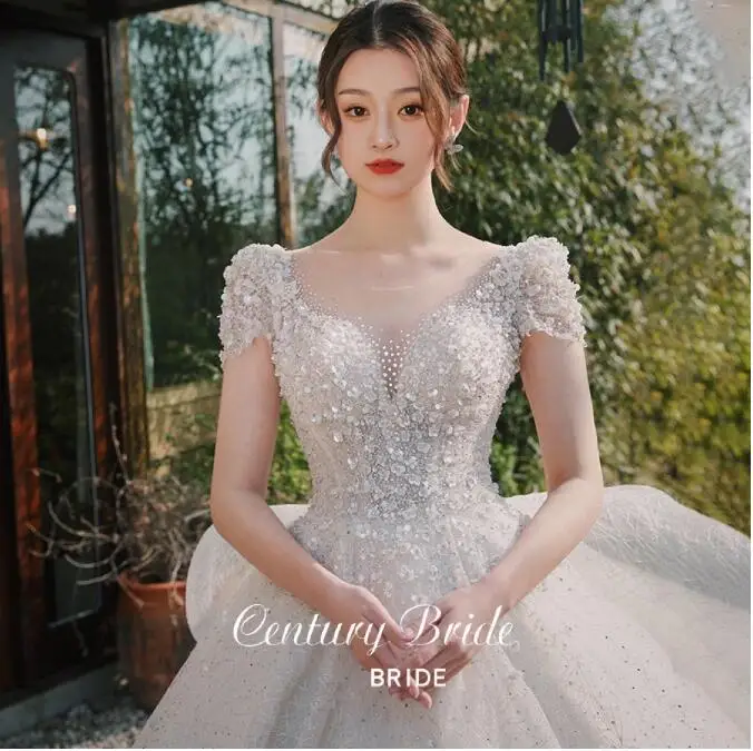 

Elegant Wedding Dresses Illusion O Neck Crystal A Line Applique Beading Princess Sweep Train Sequined Ruffle White Bridal Gowns