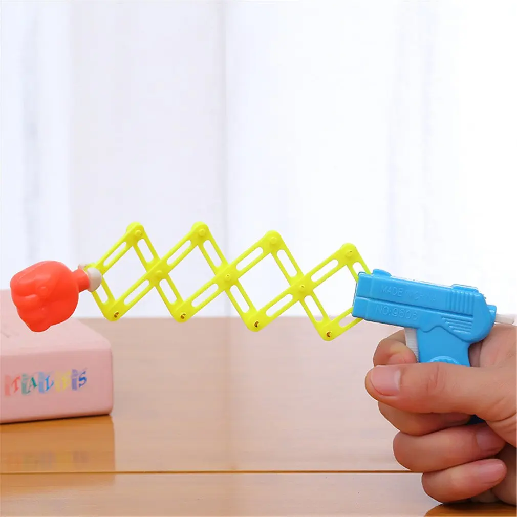 S800924e1290a4ff898ccff5fb0b6203ac Hot Funny Retractable Fist Shooter Trick Toy Funny Child Kids Plastic Party Festival Gift Classic Elastic Telescopic Fist Toy