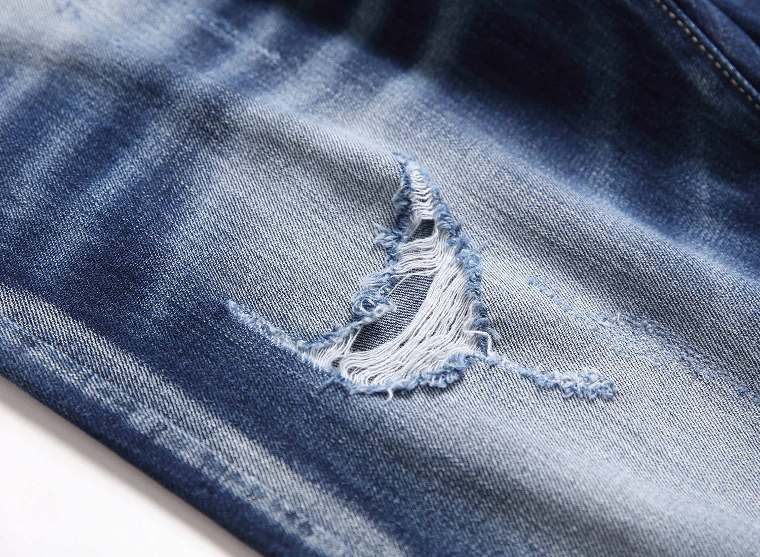 Hipster everyday dark medium pants with a lot of monkey hanging ground holes hand sweep bone guns catwhiskers jeans men