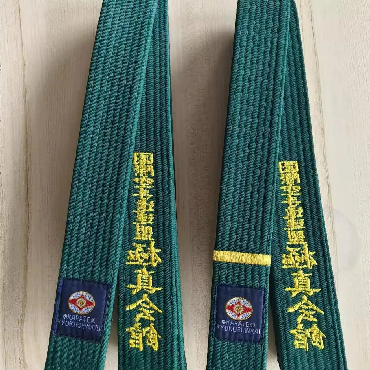 A green karate belt sold by 100 Spartans