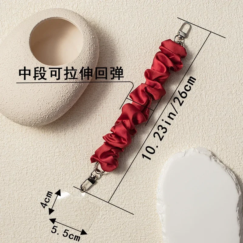 여자를위한 솔리드 컬러 전화 손목 스트랩 팔찌 여자 크리 에이 티브 Stretchable Scrunchy 모양 전화 매는 밧줄 휴대 전화 액세서리