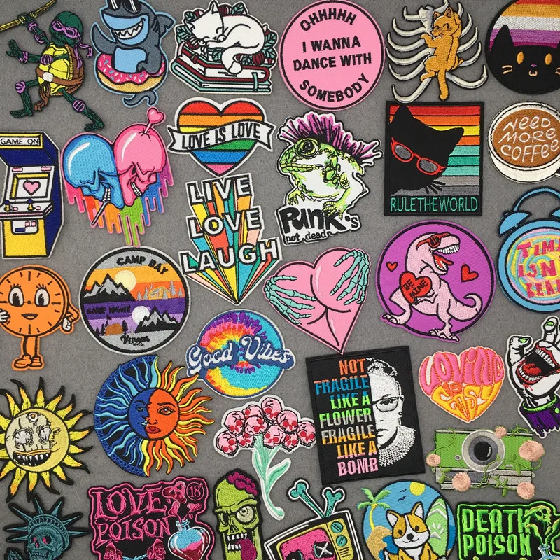 Cartoon and slogan embroidered patches – rainbow, heart, dino, sun, quotes and skull designs on grey background