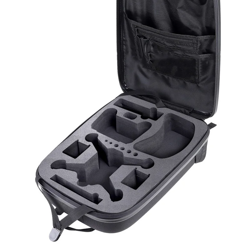 Intérieur du sac à dos étanche à coque rigide pour DJI FPV montrant les compartiments moulés pour drone et accessoires.