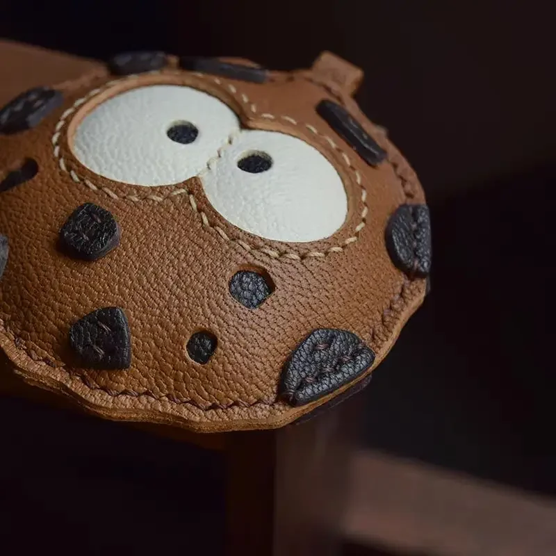 Cookie leather charm styled on handbag