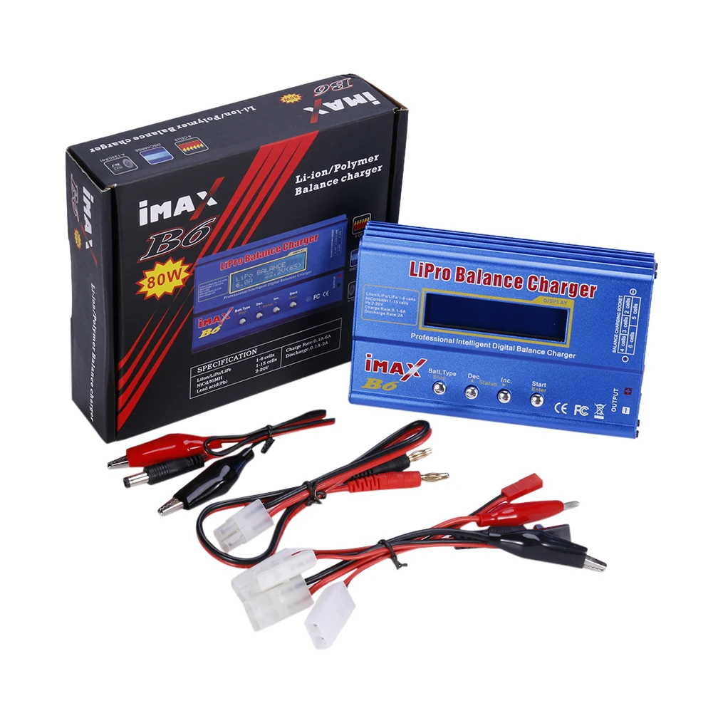 Chargeur iMAX B6 80W posé sur une table avec plusieurs batteries NiMH et LiFe à proximité