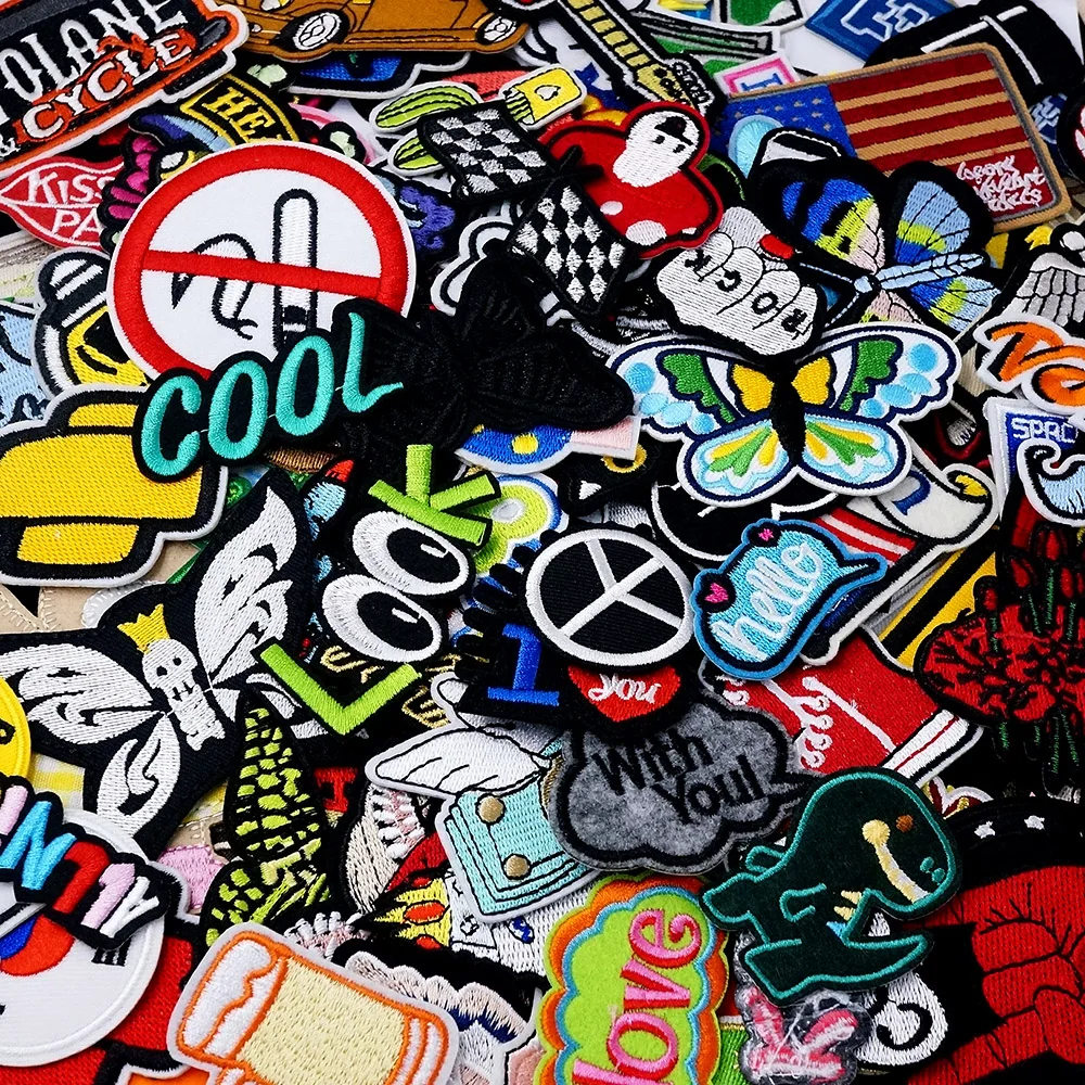 50PCS random iron-on embroidered patches with fun shapes, slogans, peace signs, butterflies, and colorful DIY icons